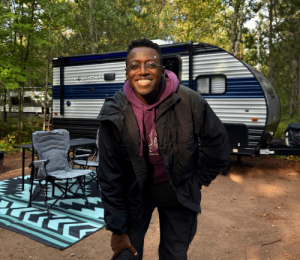 Richi standing outside the Cherokee Wolf Pup camper trailer on his first camping trip